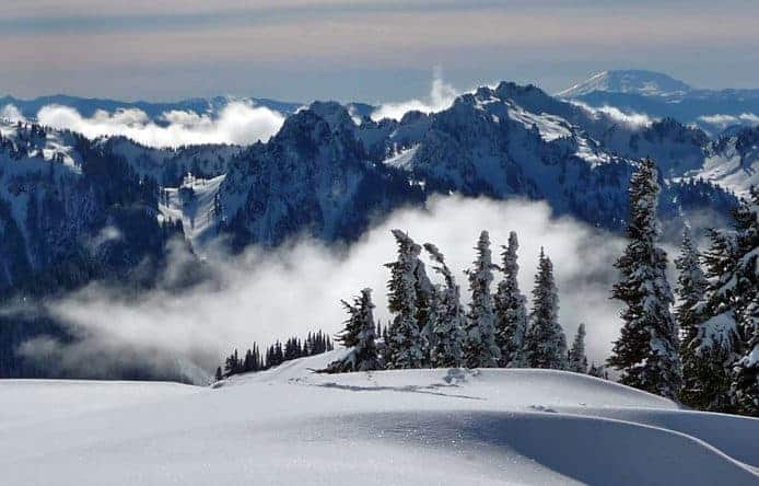 A pristine turquoise lake nestled among snow-capped mountains